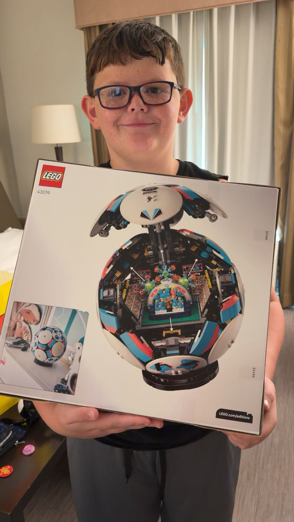 Jacob holding a soccer ball lego set