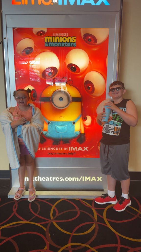 Jacob & Julie standing next to a Minions movie poster
