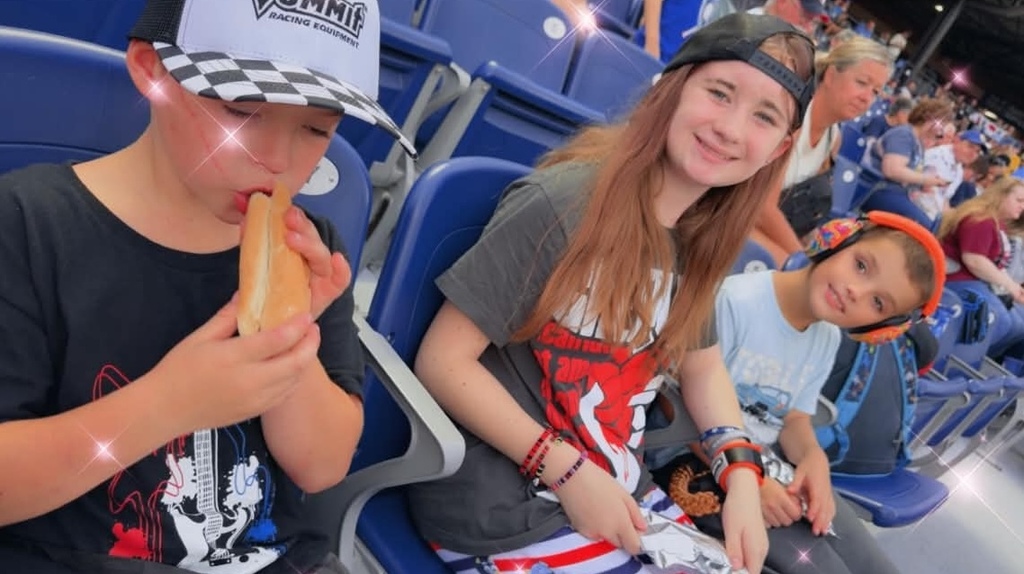 the kids sitting in their seats at the game