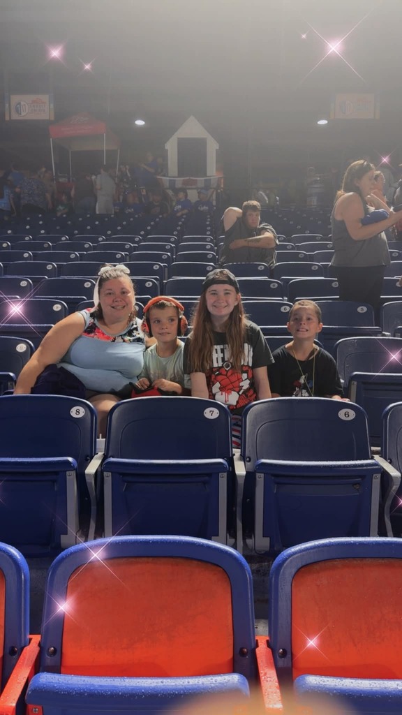 The Craig sitting in their seats at the game
