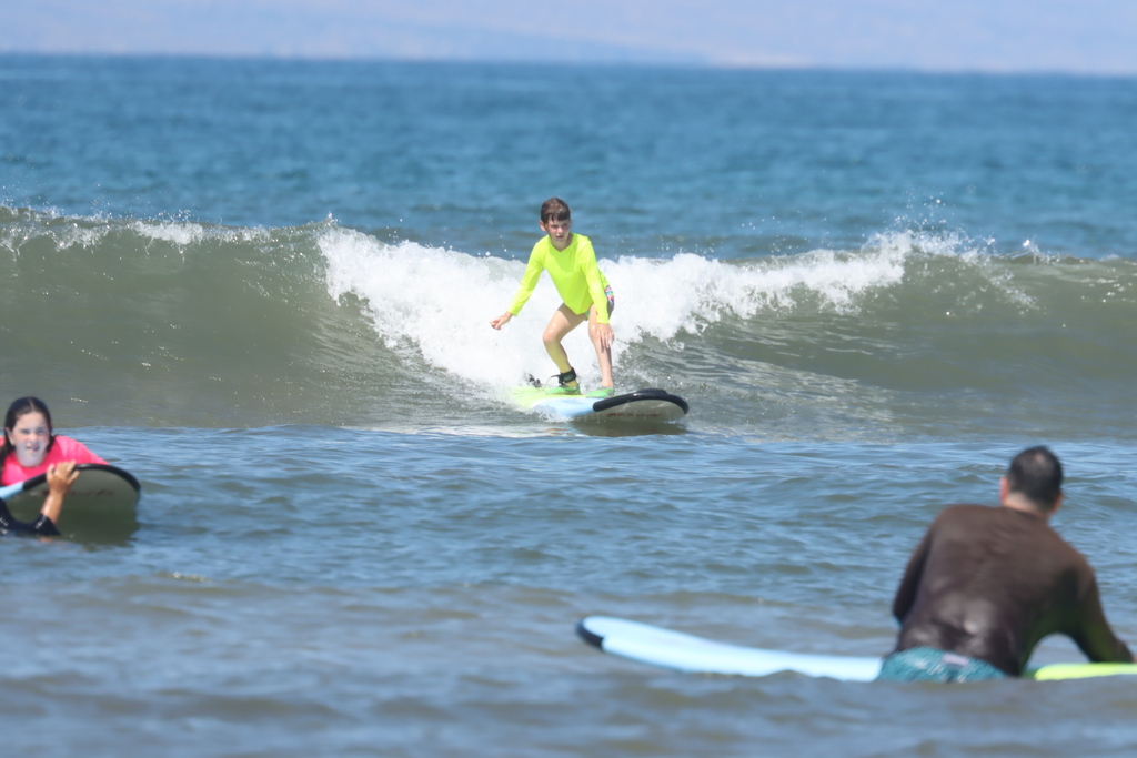 Ella surfing a wave