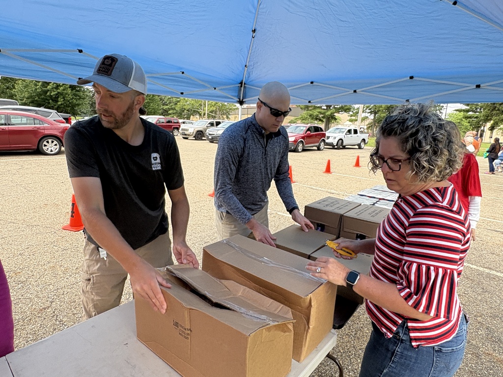 ACS staff members help to organize food on the tables before the Pop-Up Pantry started