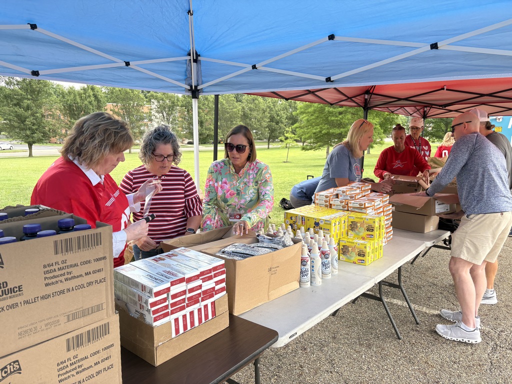 ACS staff members help to organize food on the tables before the Pop-Up Pantry started
