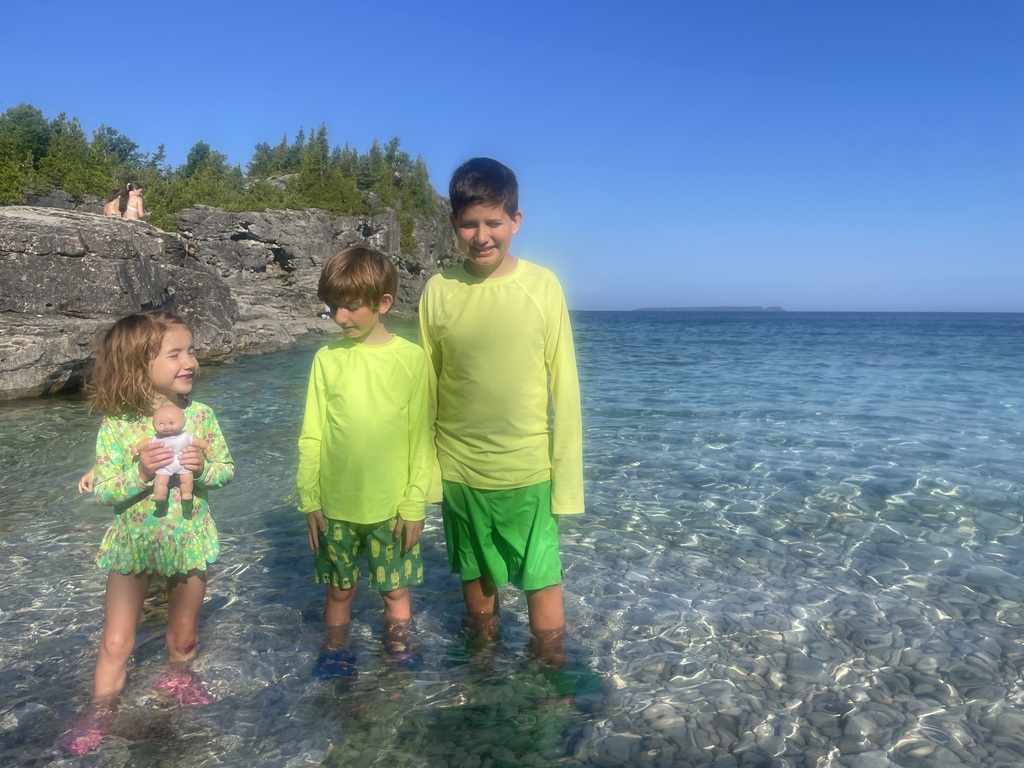 The kids standing in the water