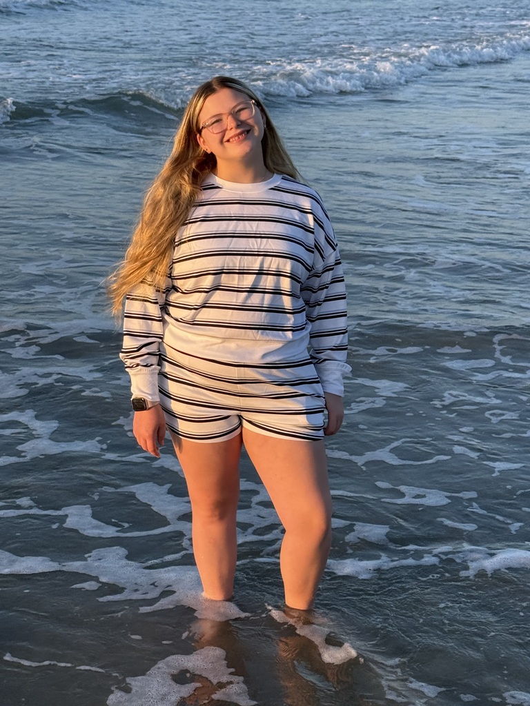 Ava standing in the ocean