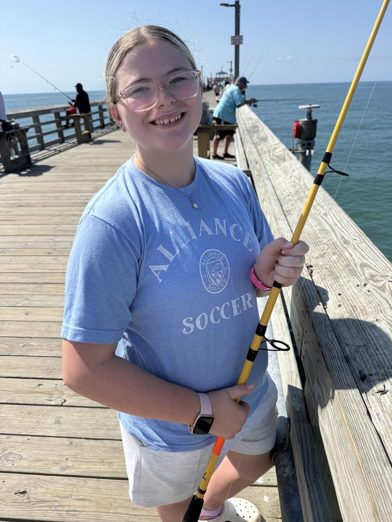 Ava fishing on a pier
