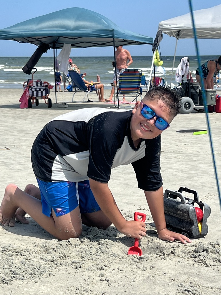 Noah digging in the sand on the beach