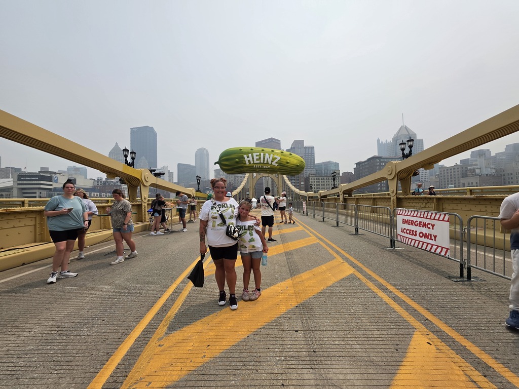 Kasidi and an older woman standing on a bridge