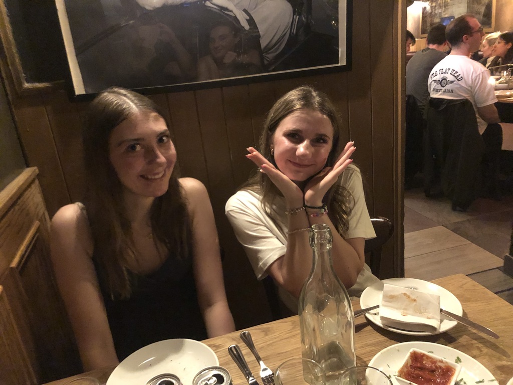 Katie and Addie sitting at a little booth in a restaurant