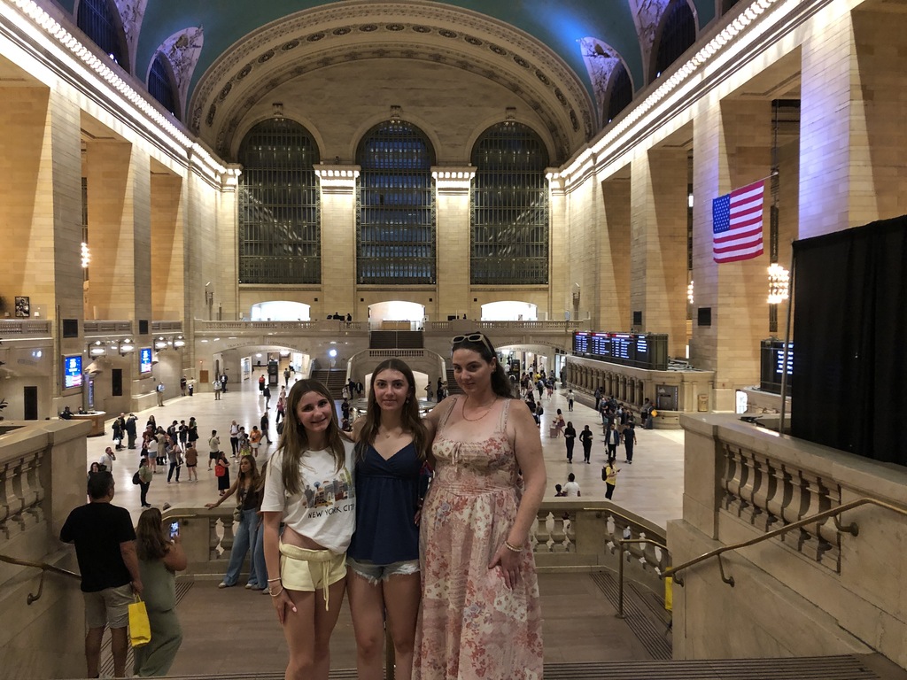 The girls posing for a picture in grand central station