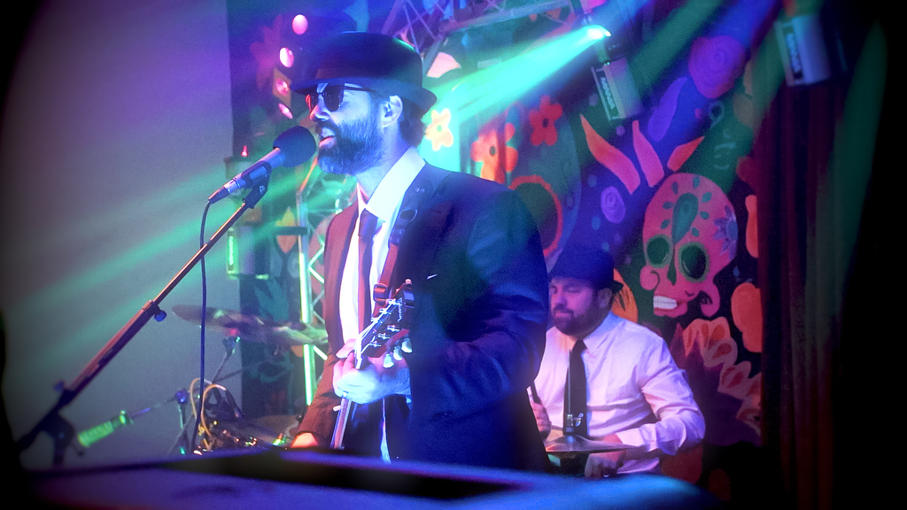 Mark Pisanello Playing the guitar on stage