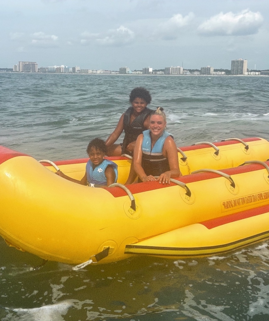 The williams family sitting on a banana boat