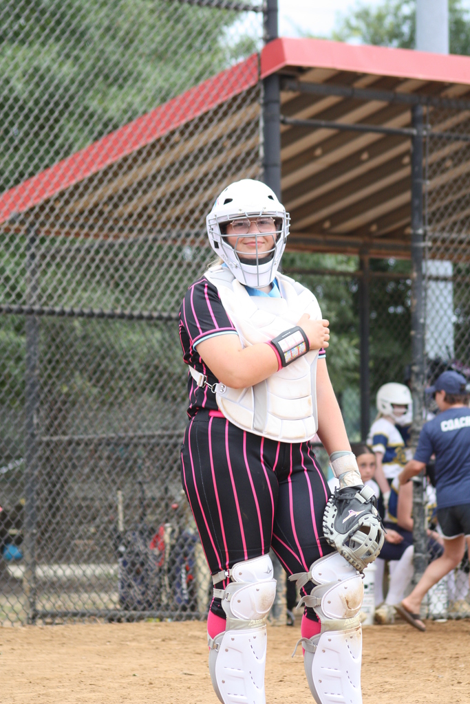 Harleigh wearing white catchers gear in a game