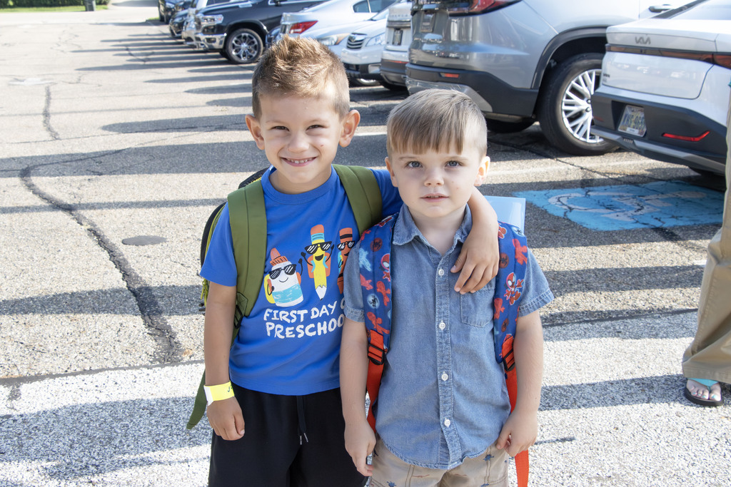 two students smiling before entering school