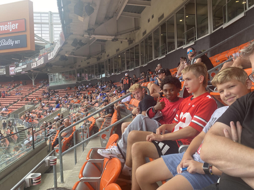 Picture of the students sitting in their seats at a stadium