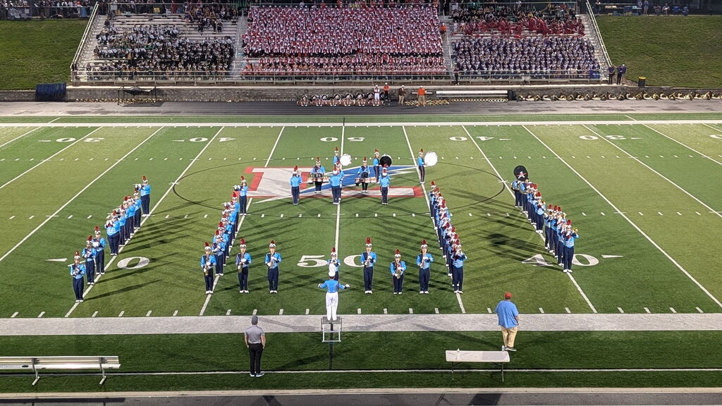 The Alliance Aviator Marching Band performing on a football field at the lake band show