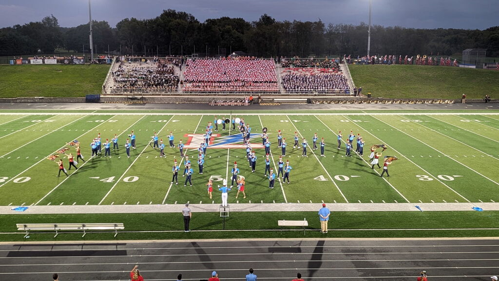 The Alliance Aviator Marching Band performing on a football field at the lake band show