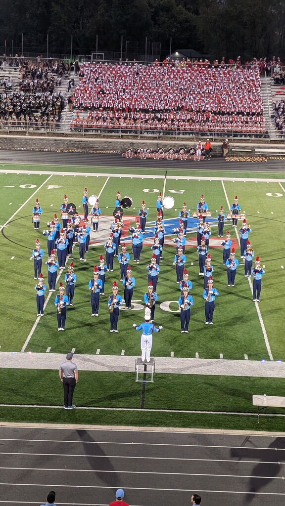 The Alliance Aviator Marching Band performing on a football field at the lake band show