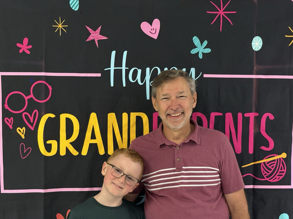 a grandfather smiles with his grandson