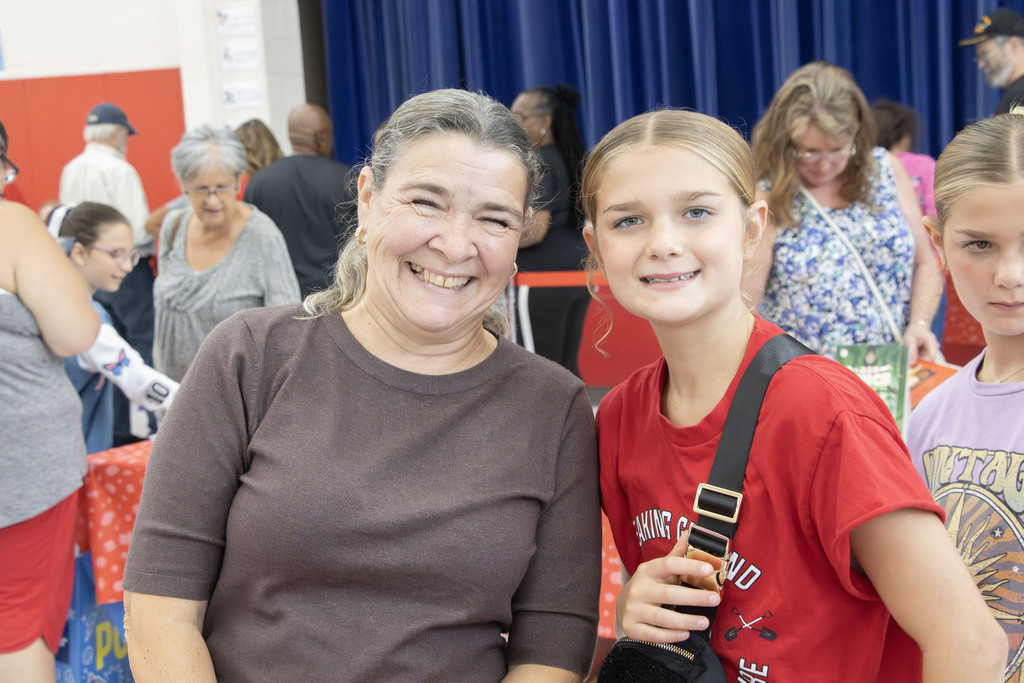 a grandmother smiles with her granddaughter