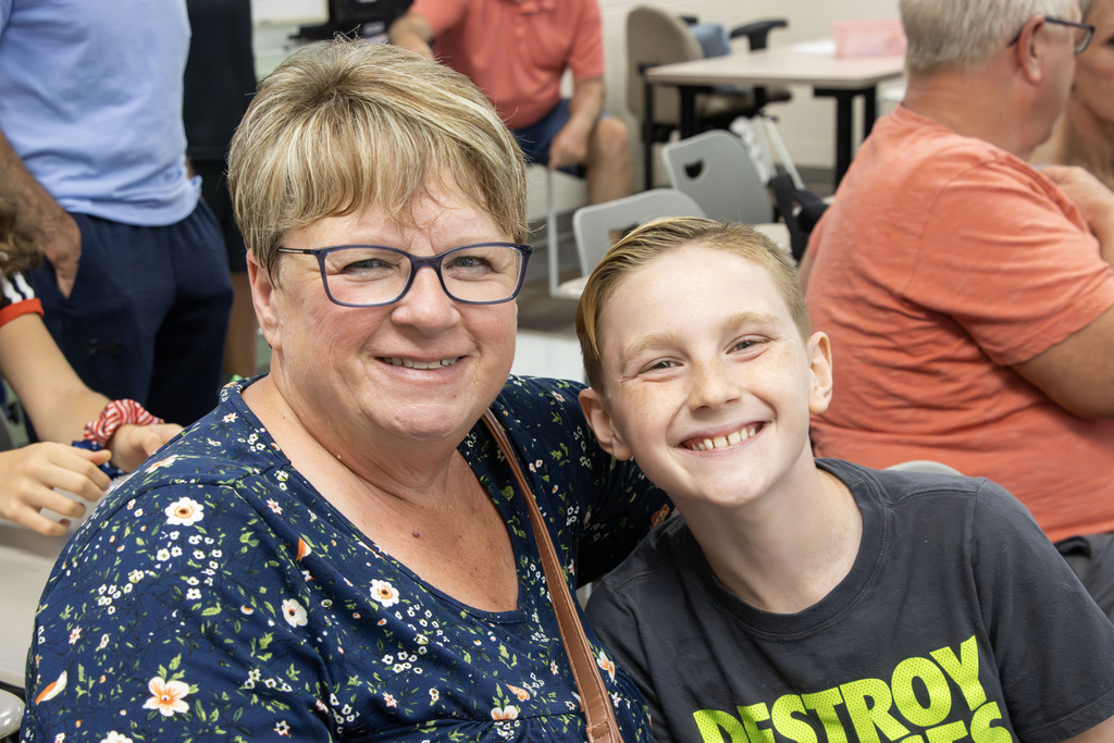 A grandmother smiles with her grandson