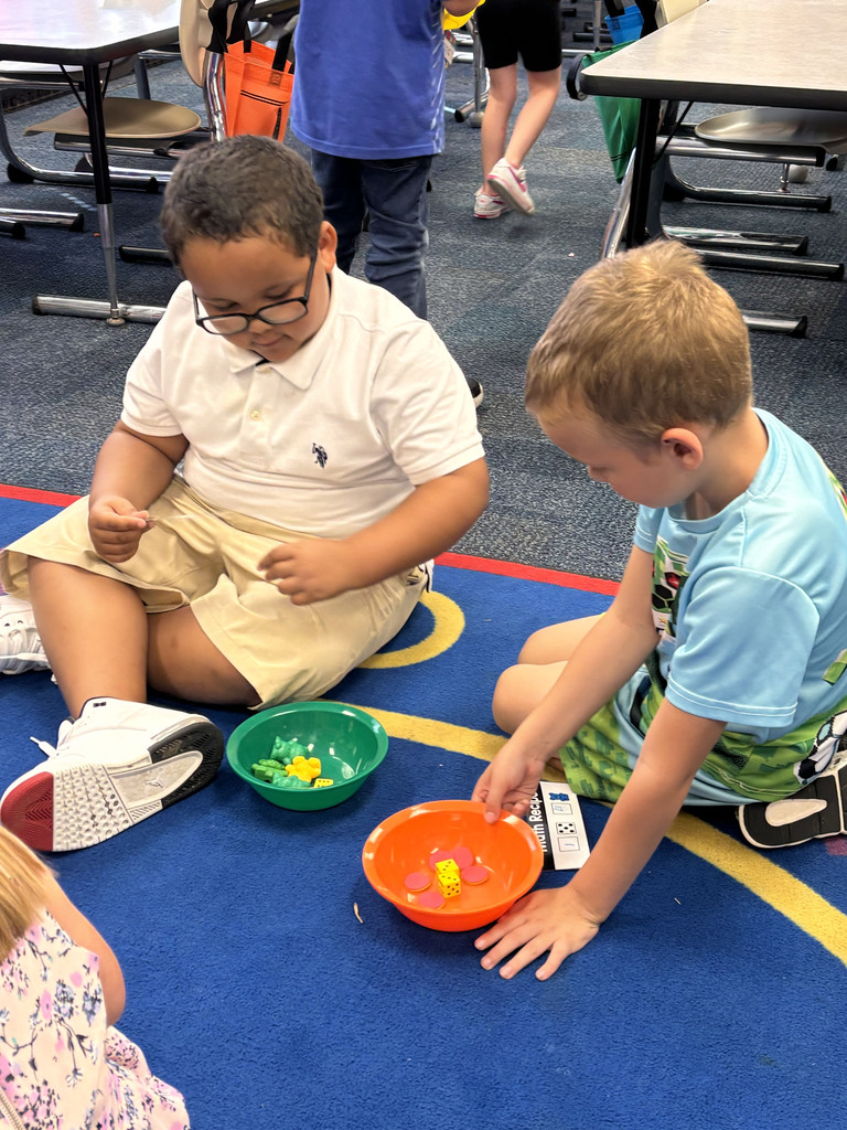 Students are following their recipe cards to make math soup with their ingredients