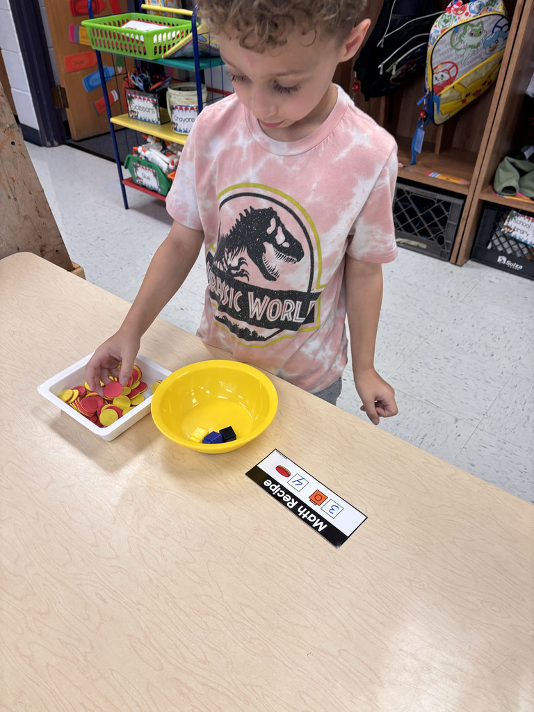 Students are following their recipe cards to make math soup with their ingredients
