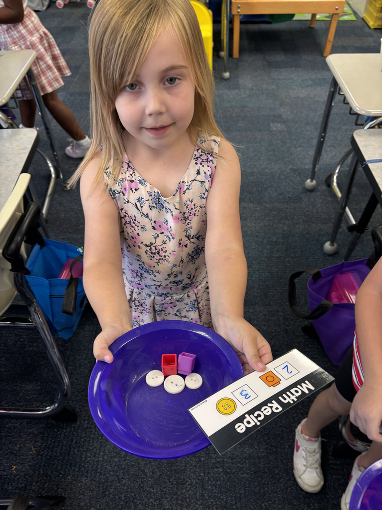 Students are following their recipe cards to make math soup with their ingredients