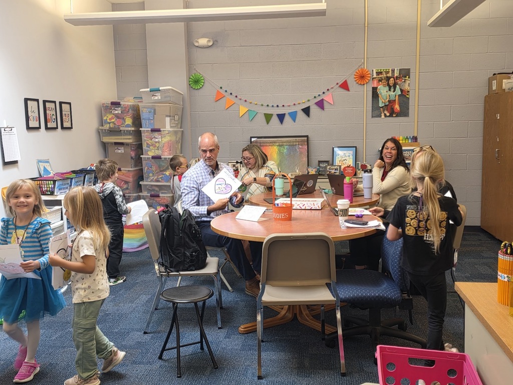 A group of students talk to a group of adults