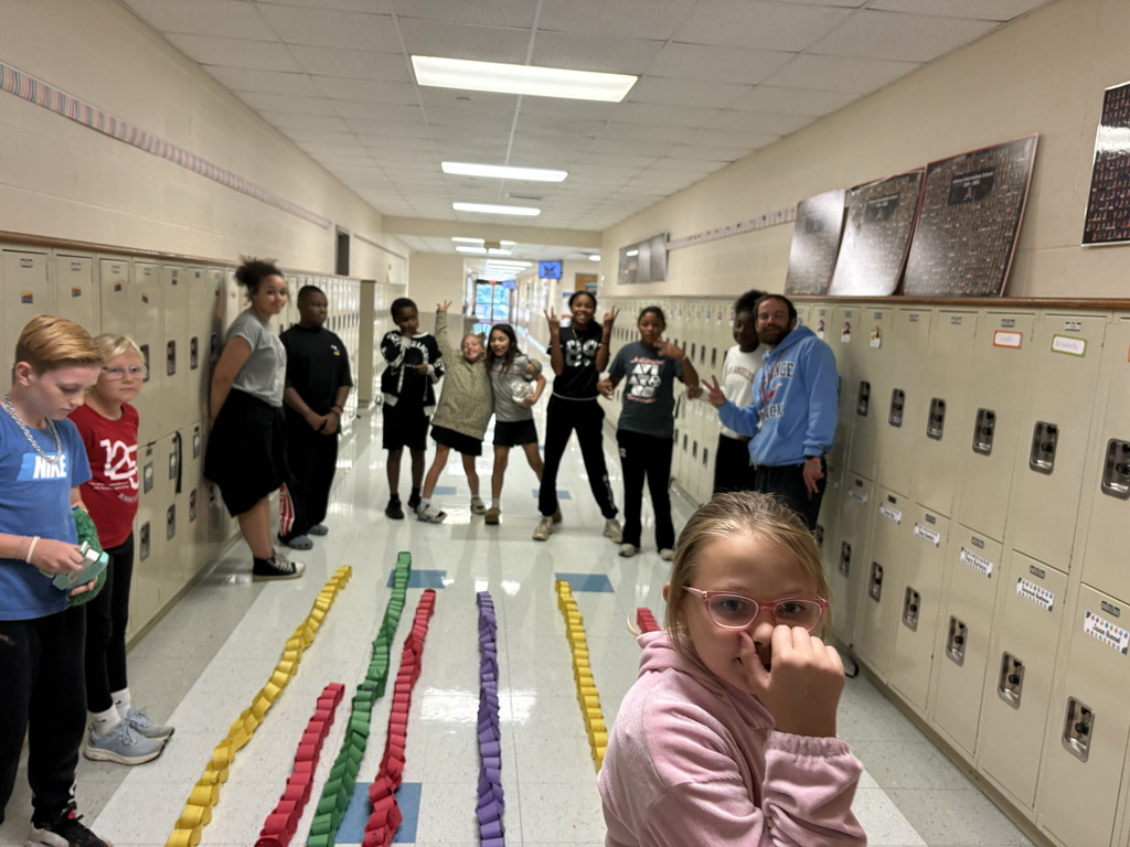 students surround the classroom changes to see who has the longest chain