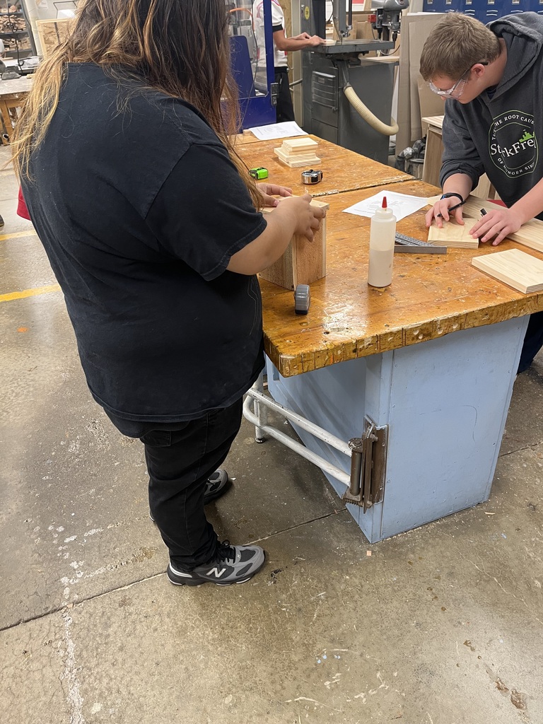students working on their wooden pumpkins in a woodshop