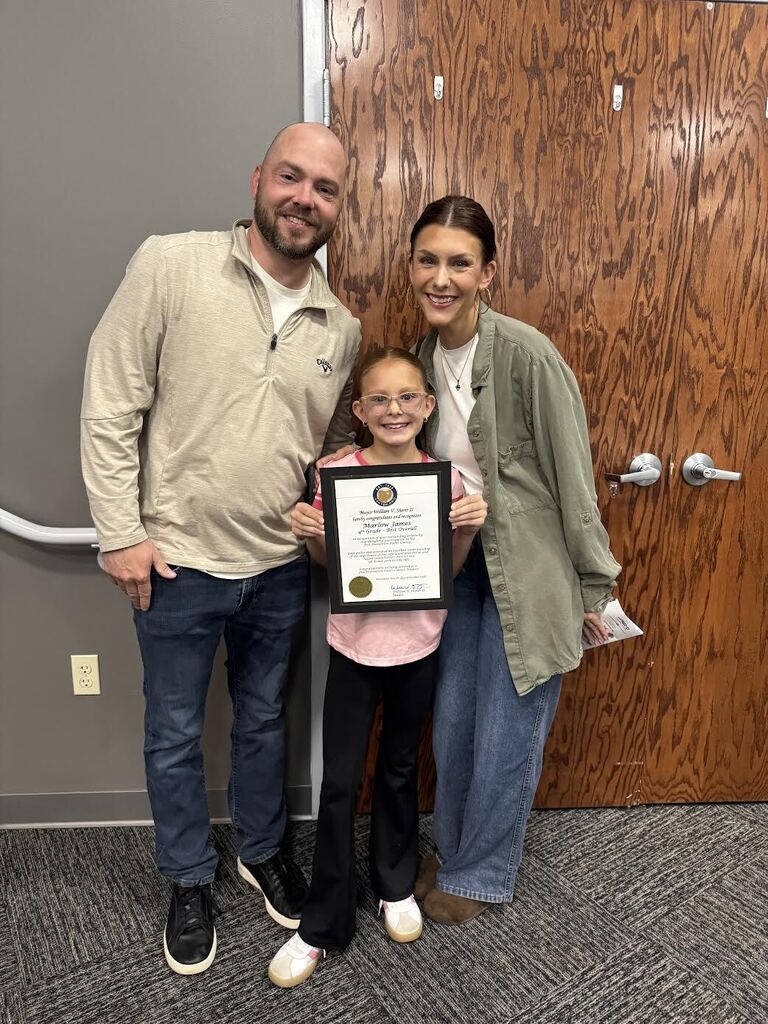 Marlow poses with her parents for a picture