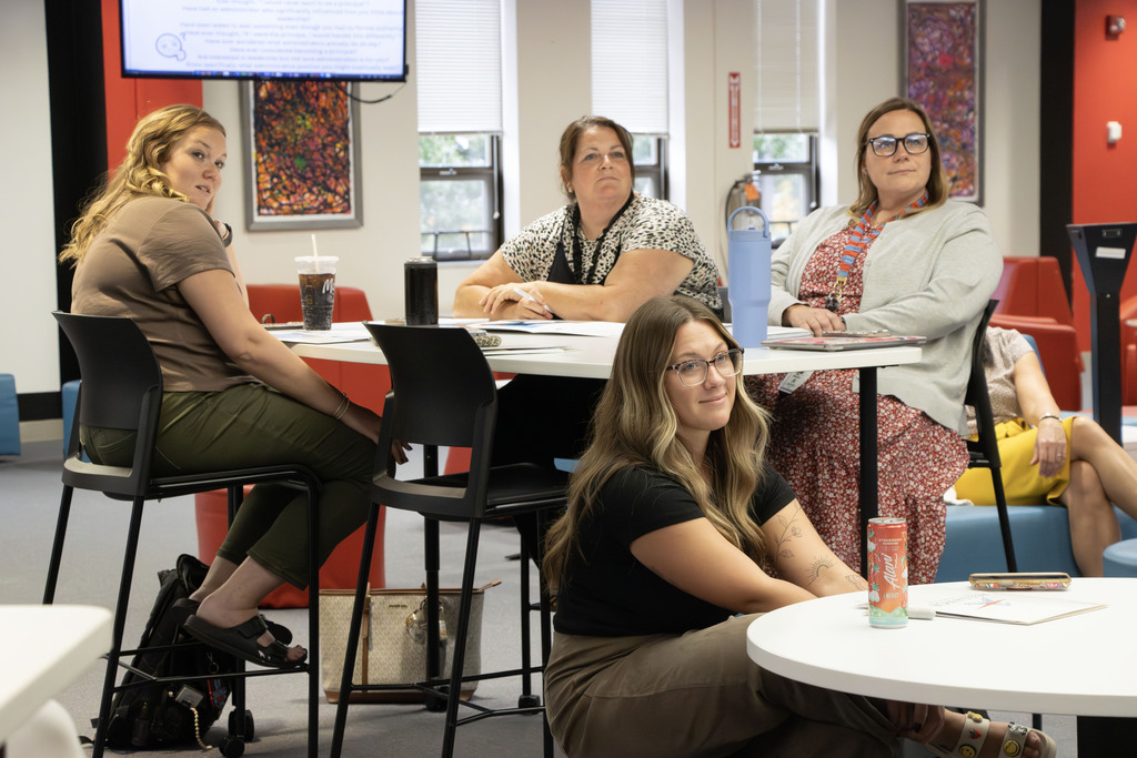ACS staff members sit in a meeting 