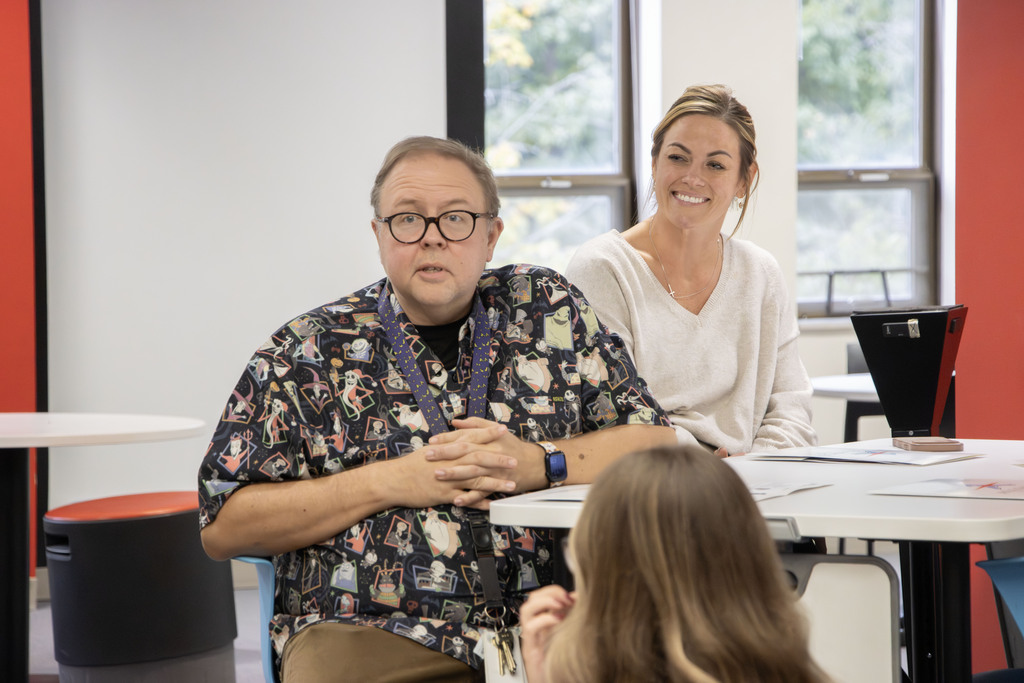 Two ACS staff members speak during a meeting