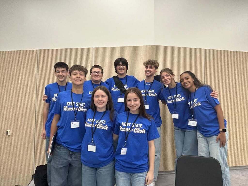 the 9 students pose for a picture wearing matching blue honors choir shirts