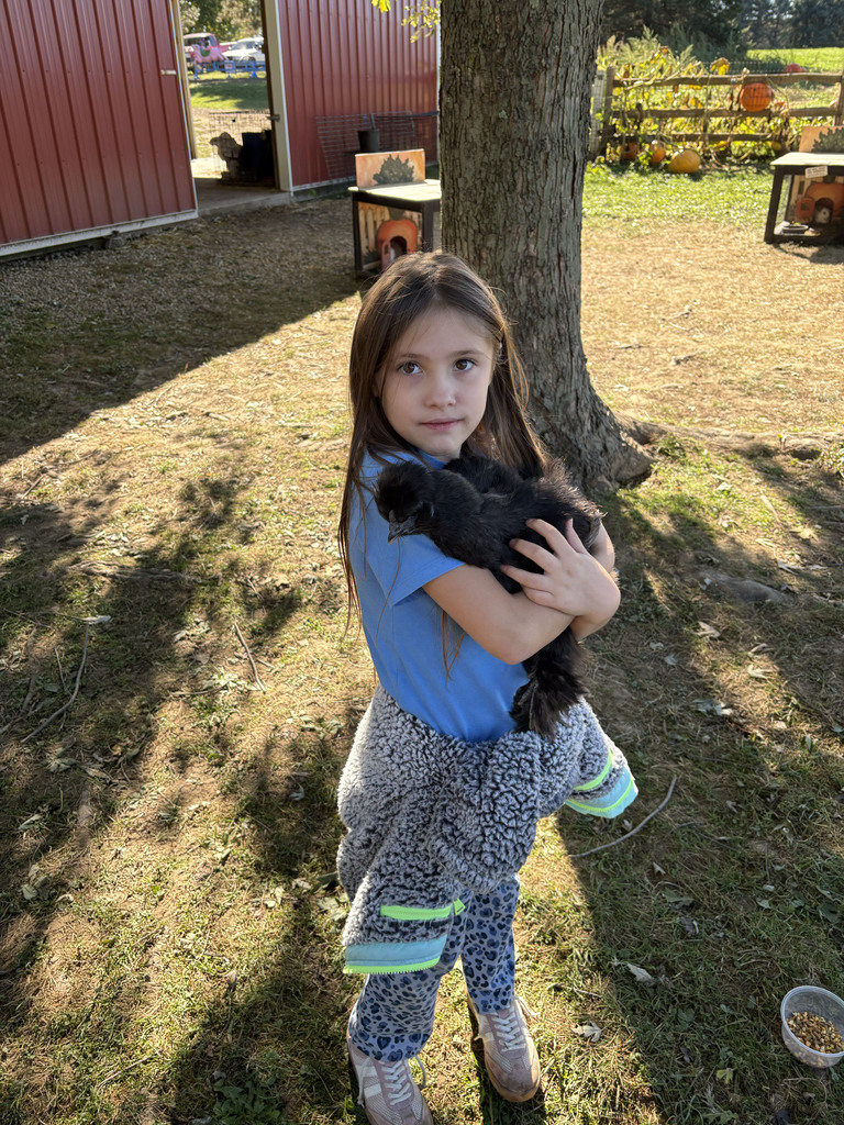 A student holds a black chicken