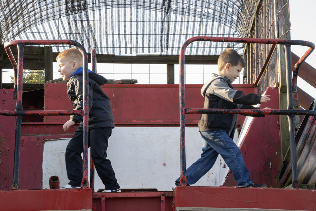 Two students run in opposite direction on a giant jungle gym