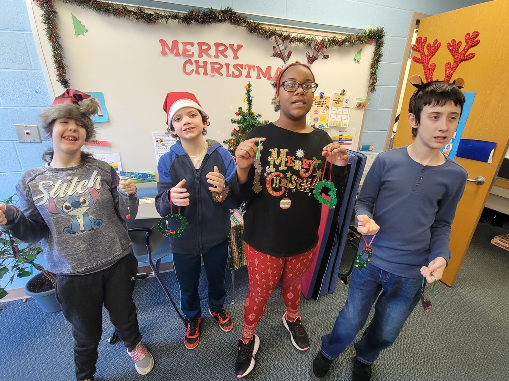 students holding the ornaments they made