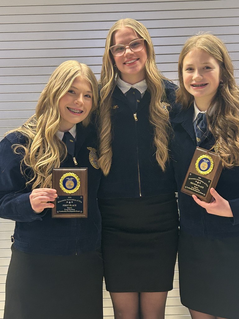 Three successful competitors pose together with their awards. From left to right: first place in Creed Speaking, a team leader, and second place in Creed Speaking. Our chapter's public speaking skills were on full display today!