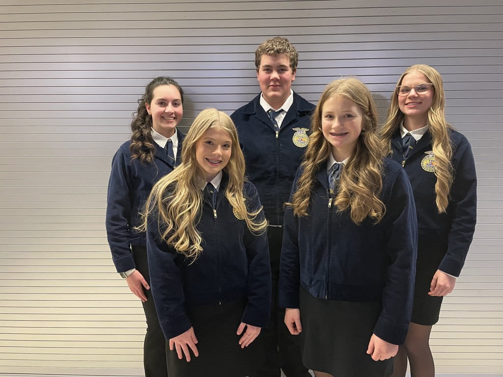 A group of five dedicated FFA members smiles for a photo in their official blue corduroy jackets. This team represented our chapter with excellence at the district level, showcasing the future of agricultural leadership.