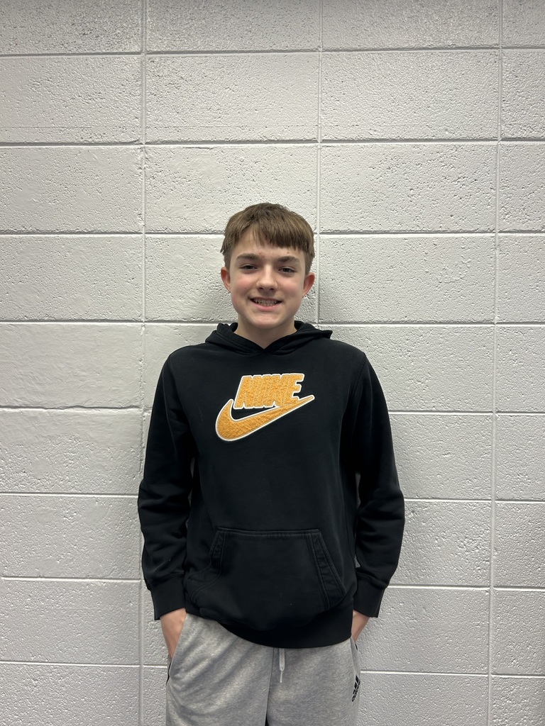 This weeks student of the week, Preson Kitzmann smiling , standing against a blank white wall. 