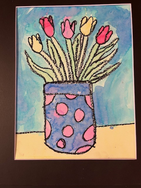 A watercolor and oil pastel drawing of tulips in a vase. Five tulips in shades of pink and yellow sit in a blue vase decorated with pink polka dots. Bold, black textured lines define the shapes against a soft blue watercolor wash.