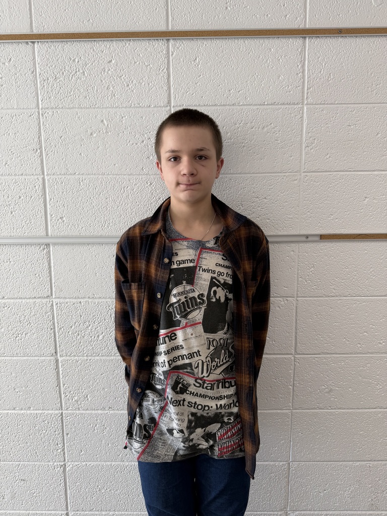 Picture of Zachary Keeler standing against a white brick wall.