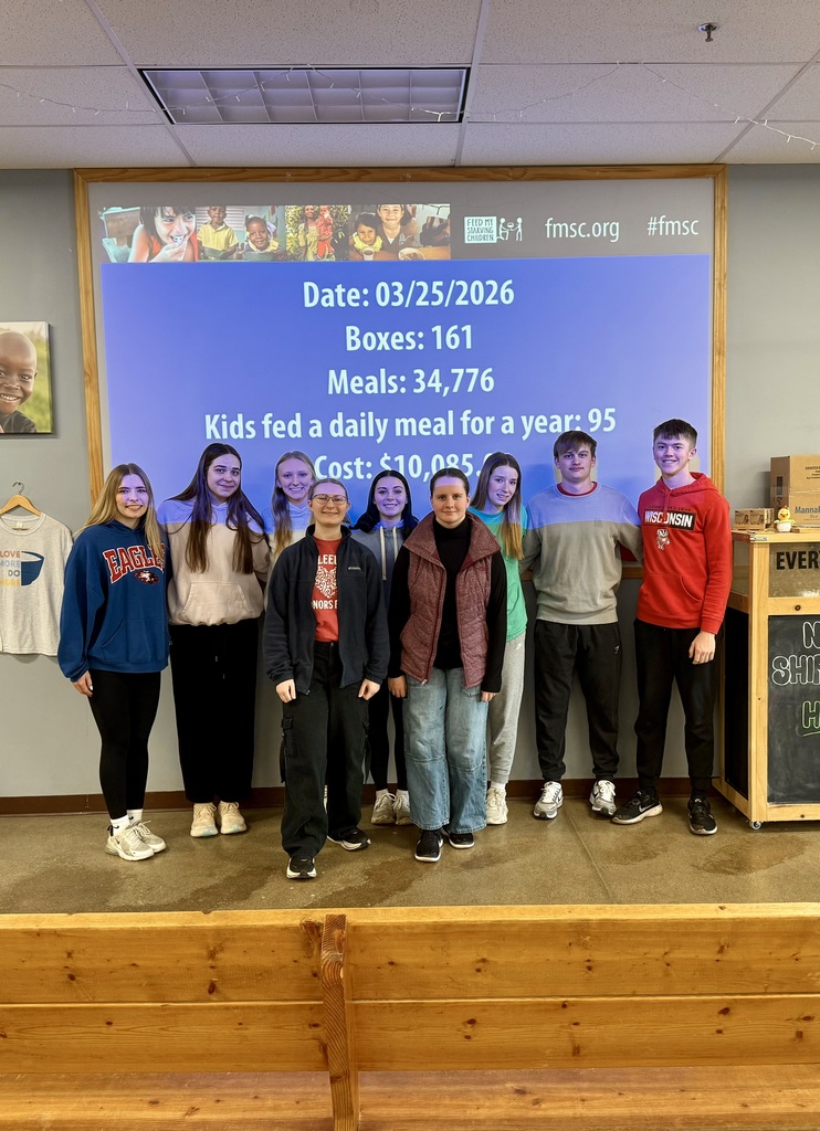 Alma's National Honor Society Members standing in front of their session's statistics