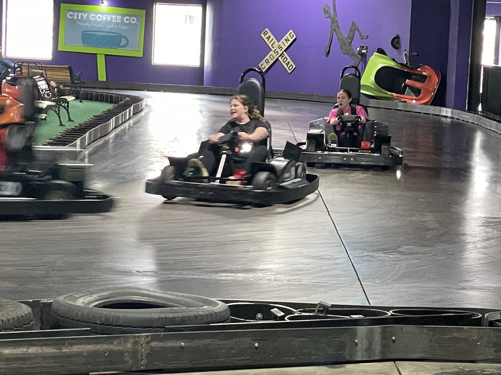 Blurry photo of a computer or tablet screen displaying an online math assignment. A geometry diagram with intersecting lines, angles, and labeled measurements is visible on the right side. The bottom shows part of a web browser interface with a URL and navigation icons. The image has glare and distortion, making most of the text difficult to read.