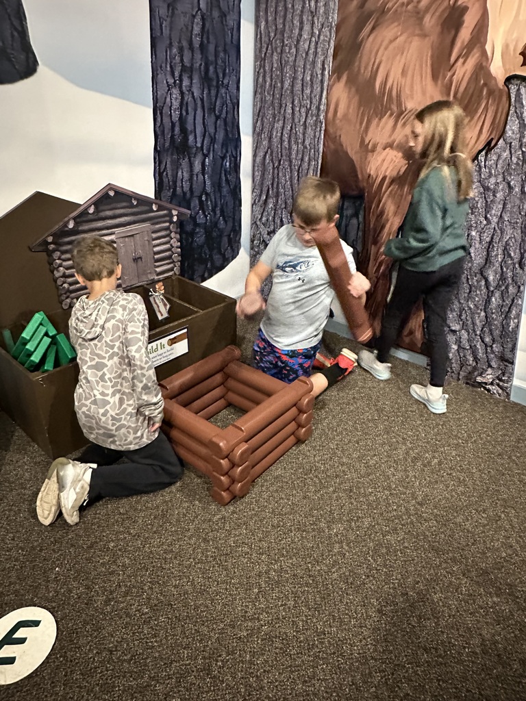 Dom and Gideon playing in the logs at the museum 