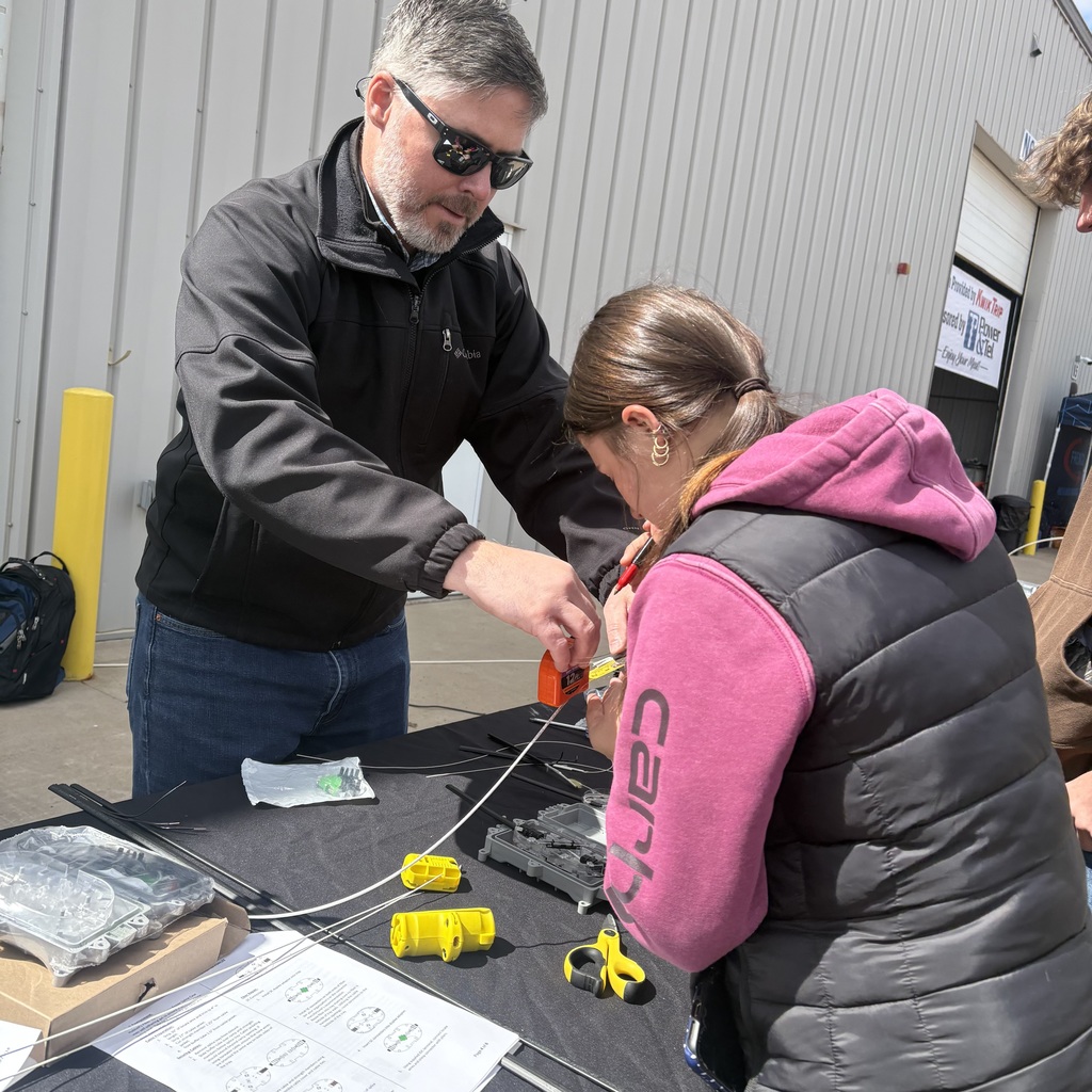 Emma McMahon stripping fiber optic wire from its case.