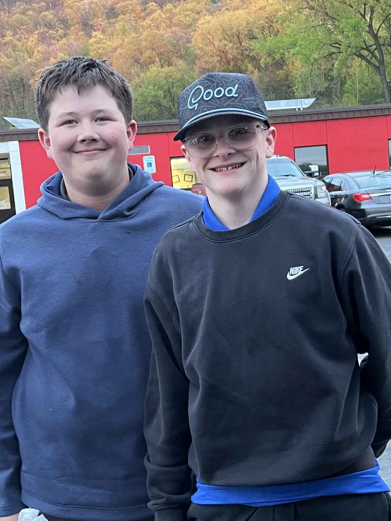 Two male golfers standing next to each other and smiling.