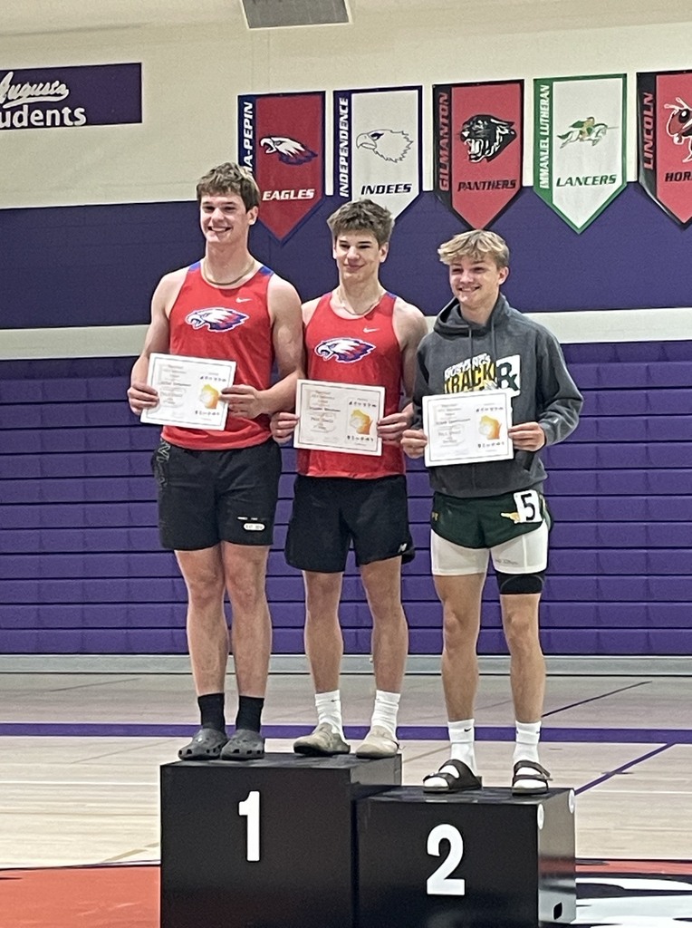 Justin and Killian Bergmann smiling on the podium. 
