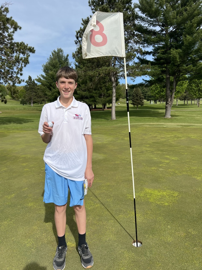 Liam Kosik smiling at the camera after chipping in for birdie on hole 8. 